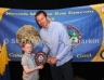 Cathal Darragh receives the U8 Bellaghy Wolftones Shield from Club – School Liaison Officer Paul Doherty